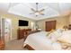 Spacious main bedroom featuring a tray ceiling and dark wood furniture at 2515 Little John Ct, Cumming, GA 30040