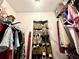 Walk-in closet with hanging clothes and multiple shelves for storage at 2515 Little John Ct, Cumming, GA 30040