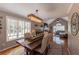 Comfortable dining room with stylish chandelier, hardwood floors, and large windows overlooking the backyard at 2515 Little John Ct, Cumming, GA 30040