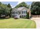 Charming two-story home featuring black shutters, a manicured lawn and inviting front entrance and manicured yard at 2515 Little John Ct, Cumming, GA 30040