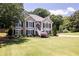 Charming two-story home featuring black shutters, a manicured lawn and inviting front entrance and manicured yard at 2515 Little John Ct, Cumming, GA 30040