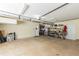 Large garage space with overhead lighting and storage shelves, offering potential for organization and projects at 2515 Little John Ct, Cumming, GA 30040