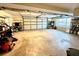Spacious garage with a roll-up door, shelving, and lots of natural light at 2515 Little John Ct, Cumming, GA 30040