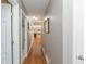 Hallway with hardwood floors, neutral wall colors, and access to a bathroom with a shower at 2515 Little John Ct, Cumming, GA 30040