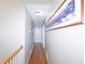 Hallway with hardwood flooring and neutral paint highlighted by the artwork at 2515 Little John Ct, Cumming, GA 30040