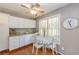 Cozy kitchen nook with white cabinets, granite counters, and a charming breakfast area at 2515 Little John Ct, Cumming, GA 30040