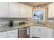 Kitchen featuring stainless steel dishwasher and granite countertops at 2515 Little John Ct, Cumming, GA 30040