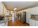 Spacious kitchen featuring stainless steel appliances, white cabinets, and hardwood floors at 2515 Little John Ct, Cumming, GA 30040