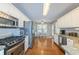 Well-lit kitchen features stainless appliances, granite countertops, and hardwood floors leading to an eat-in area at 2515 Little John Ct, Cumming, GA 30040