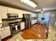 Bright kitchen boasts stainless steel appliances, granite countertops, and hardwood flooring at 2515 Little John Ct, Cumming, GA 30040