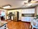 Spacious kitchen features stainless steel appliances, granite counters, and hardwood floors at 2515 Little John Ct, Cumming, GA 30040