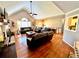 Bright living area featuring hardwood floors, a fireplace, and comfortable leather seating at 2515 Little John Ct, Cumming, GA 30040
