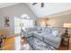 Bright and airy living room with large windows and a comfortable sectional sofa at 2515 Little John Ct, Cumming, GA 30040
