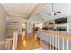 Open-concept living room featuring hardwood floors, a cozy fireplace, and views of the adjacent dining area at 2515 Little John Ct, Cumming, GA 30040