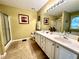 This main bathroom features double sinks, a framed mirror, and a large tub/shower combo at 2515 Little John Ct, Cumming, GA 30040