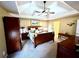 This main bedroom boasts a trey ceiling, ceiling fan, and access to the main bathroom at 2515 Little John Ct, Cumming, GA 30040
