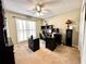 Functional home office space with dark furniture, carpet, and a ceiling fan at 2515 Little John Ct, Cumming, GA 30040
