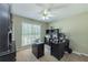 Bright office featuring a large window and a ceiling fan, with carpeted floors and a dark furniture set at 2515 Little John Ct, Cumming, GA 30040