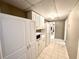 Bright pantry featuring tile flooring and white cabinetry provides ample storage solutions at 2515 Little John Ct, Cumming, GA 30040