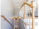 Staircase with wooden handrails leading to a lower level, offering a glimpse into the dining area at 2515 Little John Ct, Cumming, GA 30040