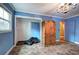 Bedroom featuring blue walls, tile flooring, natural light, and a large storage wardrobe at 4128 Worth Nw St, Acworth, GA 30101