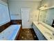 Bathroom with a soaking tub, double vanity, and neutral tile flooring, perfect for relaxation and convenience at 2822 Salem Oak Way, Duluth, GA 30096