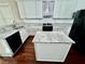 Stylish kitchen with white cabinets, center island, and sleek black appliances at 2822 Salem Oak Way, Duluth, GA 30096