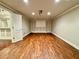 Spacious rec room with paneled walls, wood floors and large blank wall for entertaining at 2822 Salem Oak Way, Duluth, GA 30096
