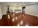 Spacious living room with hardwood floors, bar, and easy access to multiple rooms at 2822 Salem Oak Way, Duluth, GA 30096