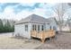 Backyard view featuring wood deck and gray siding of the house; bordered with leafless trees at 5995 Crowley Dr, Douglasville, GA 30135