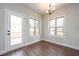 Bright dining area with wood floors, two windows, and access to outdoor deck at 5995 Crowley Dr, Douglasville, GA 30135