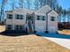 Charming two-story home featuring a two-car garage, gray facade, stone accents, and landscaped front yard at 5995 Crowley Dr, Douglasville, GA 30135