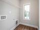 Laundry room with shelving, a window and hookups for the washer and dryer at 5995 Crowley Dr, Douglasville, GA 30135