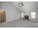 Cozy living room featuring vaulted ceilings, plush carpeting, a stone fireplace, and neutral paint at 5995 Crowley Dr, Douglasville, GA 30135