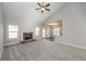 Living room featuring vaulted ceilings, plush carpeting, a fireplace, and an open layout to the kitchen at 5995 Crowley Dr, Douglasville, GA 30135