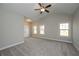 Spacious main bedroom with vaulted ceiling, ceiling fan, carpeted floor, and three windows at 5995 Crowley Dr, Douglasville, GA 30135