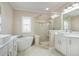 Bright bathroom with a standalone tub and separate glass shower at 928 Boudreau Ct, Atlanta, GA 30328