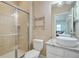 Bathroom showcasing a vessel sink, granite countertop, glass shower door, and modern light fixture at 928 Boudreau Ct, Atlanta, GA 30328