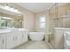 A luxurious bathroom with a soaking tub and glass shower at 928 Boudreau Ct, Atlanta, GA 30328