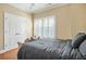 Bedroom features wood floors, a queen size bed and a large window at 928 Boudreau Ct, Atlanta, GA 30328