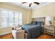 Bedroom with wood floors, large window, ceiling fan and full size bed at 928 Boudreau Ct, Atlanta, GA 30328