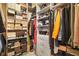 Walk-in closet with boxes, shelving, and hanging clothes at 928 Boudreau Ct, Atlanta, GA 30328