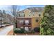 Townhome exterior with brick and siding, mature trees, two balconies and well-maintained landscaping at 928 Boudreau Ct, Atlanta, GA 30328