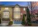 Beautiful townhome shows an attached garage with blue doors and landscaped front yard at 928 Boudreau Ct, Atlanta, GA 30328