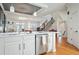 Modern kitchen featuring stone backsplash, white cabinets, and stainless steel appliances at 928 Boudreau Ct, Atlanta, GA 30328