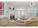Cozy living room with fireplace, TV, elegant decor, and natural light from a large window at 928 Boudreau Ct, Atlanta, GA 30328