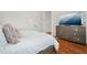 Main bedroom with white bedding, hardwood floors and a large dresser beneath a wall-mounted TV at 928 Boudreau Ct, Atlanta, GA 30328