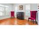 Elegant sitting area with hardwood floors, bright windows, and two stylish red chairs at 928 Boudreau Ct, Atlanta, GA 30328