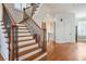 Elegant staircase with dark wood railings, white trim, and plenty of natural light at 928 Boudreau Ct, Atlanta, GA 30328