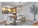 Cozy dining area featuring a wooden table, white chairs, and modern lighting at 1468 Briarwood Ne Rd # 502, Brookhaven, GA 30319